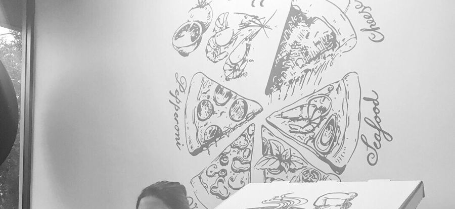 The hand-drawn pizza mural on the dining room wall at Uncle Reds Pizzeria